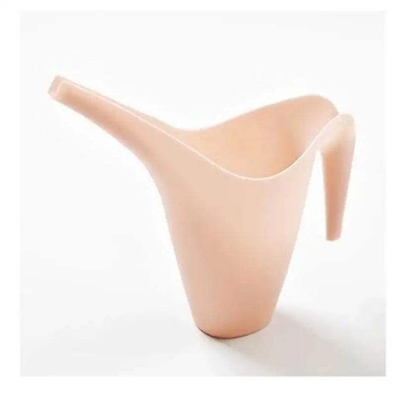 a small beige vase with a curved handle