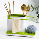 a green and white utt with a spoon, fork and a napkin