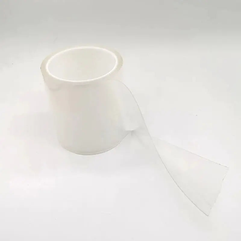 a roll of clear adhesive on a white background