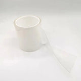 a roll of clear adhesive on a white background