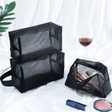 a black bag with makeup and lipstick on it