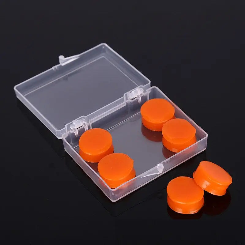 there are four orange pill caps in a clear case