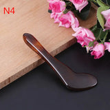 a spoon with a wooden handle on a table