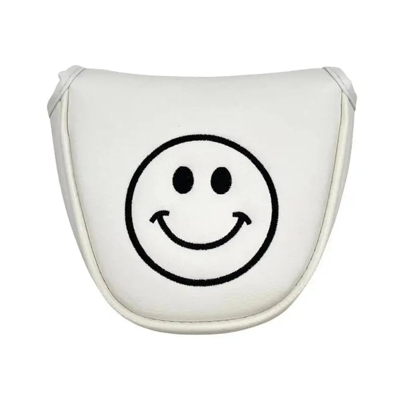 a white smiley face shaped pillow with a black smiley face
