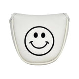 a white smiley face shaped pillow with a black smiley face