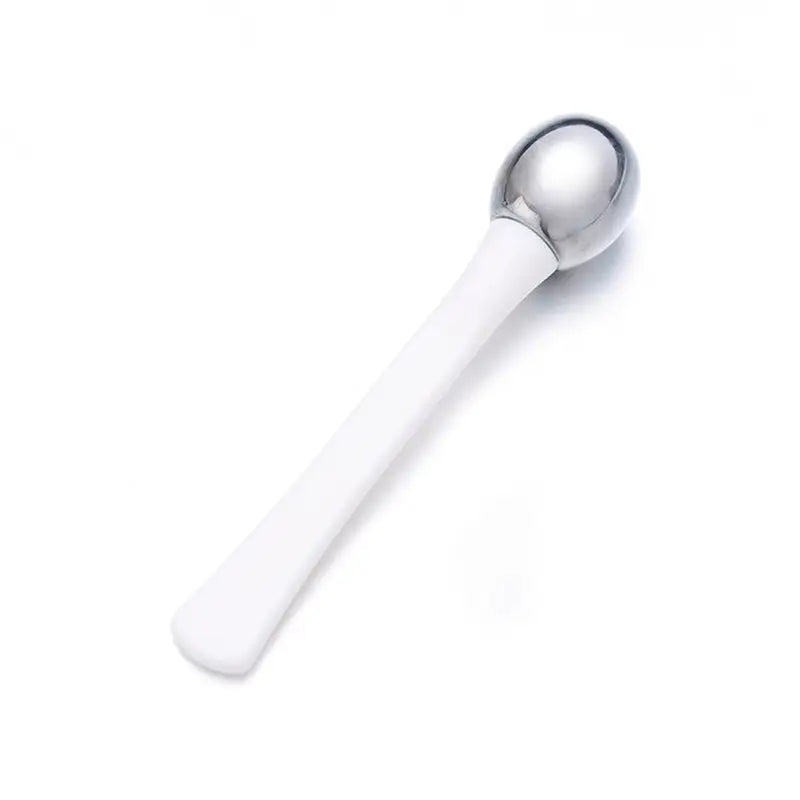 a spoon with a white handle and a silver handle