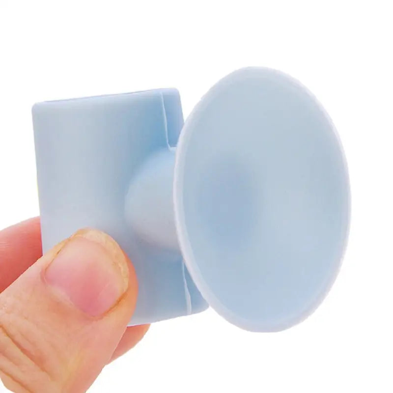 a hand holding a blue plastic knob