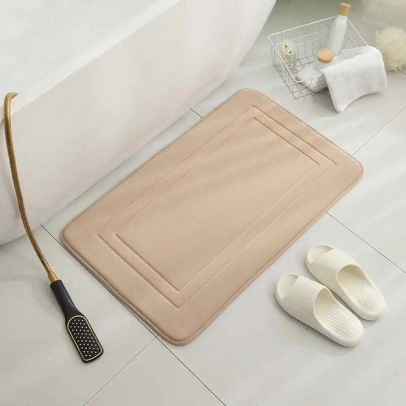 a bath mat with a brush and a towel