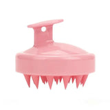 a pink plastic brush with spikes