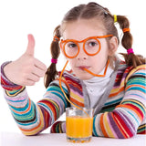 a little girl with glasses and a glass of orange juice
