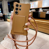 Tan smartphone case with multiple camera cutouts, a card slot, and an attached lanyard.