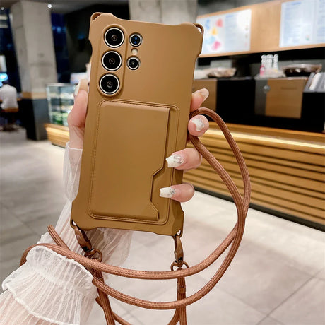 Tan smartphone case with multiple camera cutouts, a card slot, and an attached lanyard.