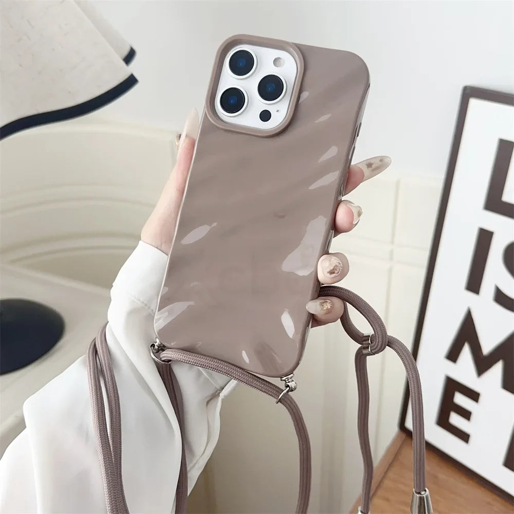 Taupe phone case with crossbody strap.