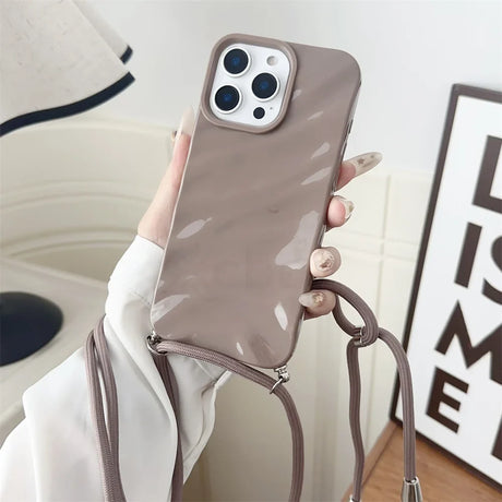 Taupe phone case with crossbody strap.
