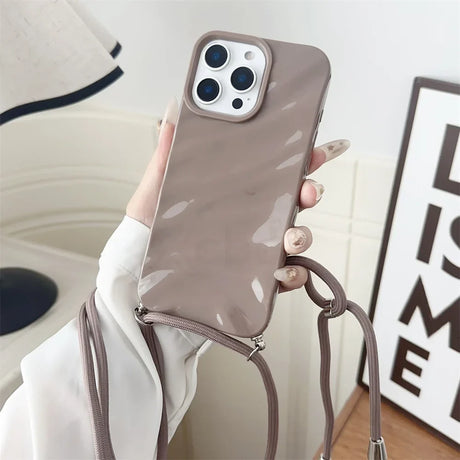 Taupe phone case with crossbody strap.