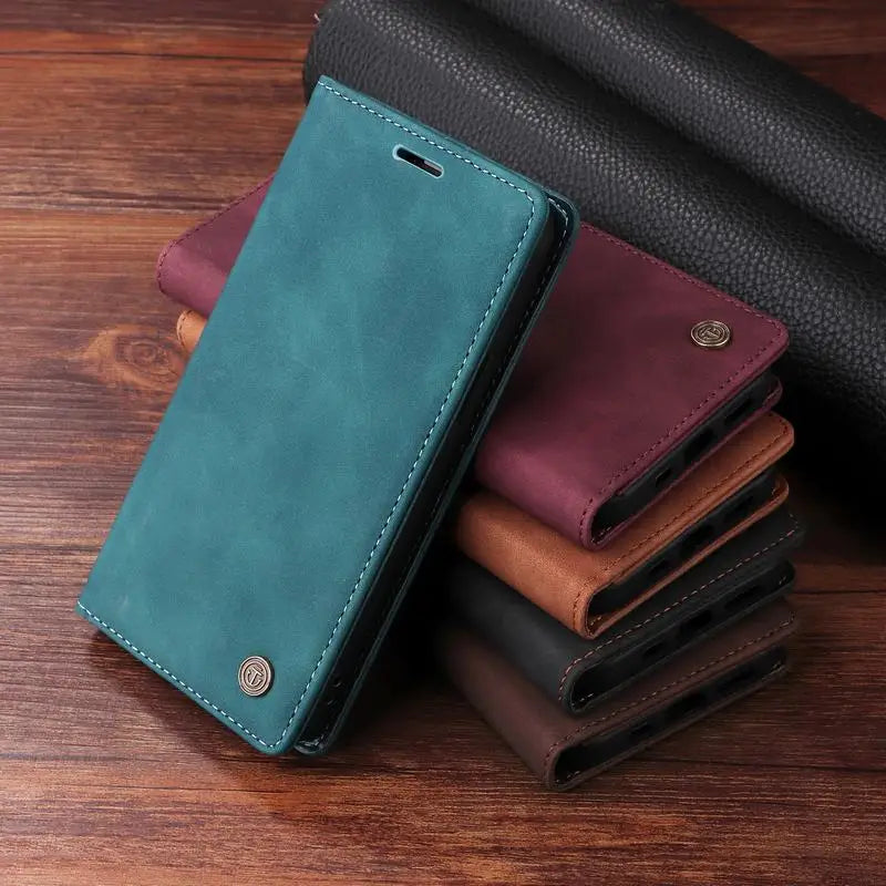 Teal leather wallet or phone case with a metallic button closure.