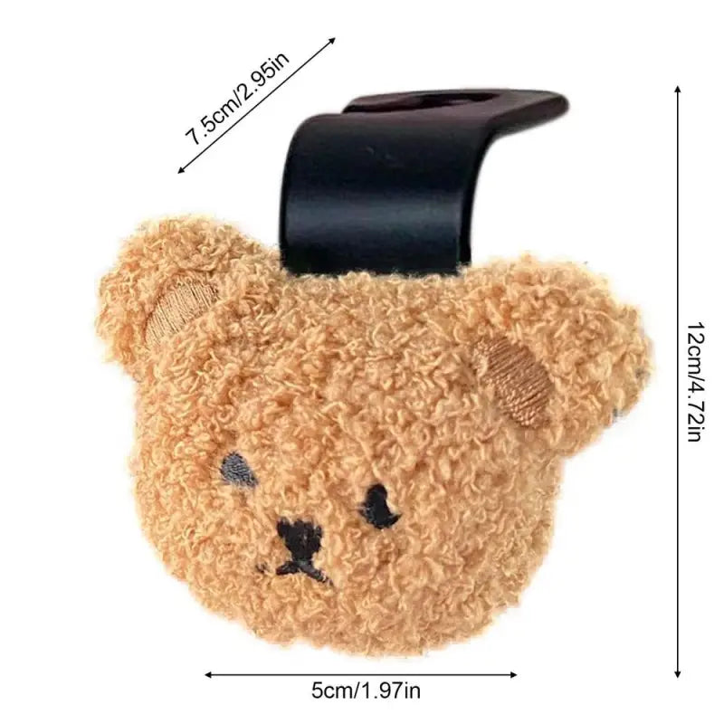 a teddy bear shaped phone holder with a black strap
