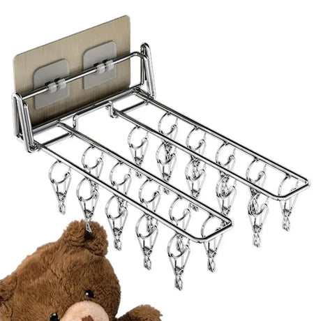 a teddy bear is hanging on a wall mounted towel rack