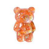 a teddy bear made out of orange and white crystals