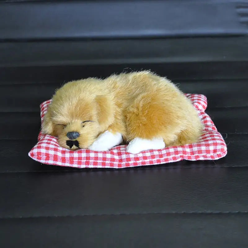 a teddy bear is sleeping on a red and white checkered blanket