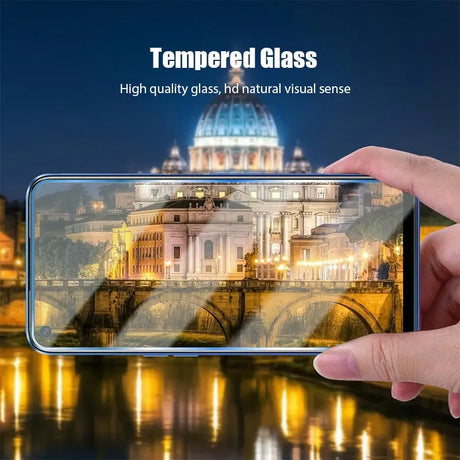 a person holding a phone with the text’tempered glass ’