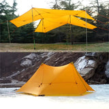 a yellow tent with a black and white tent in the background