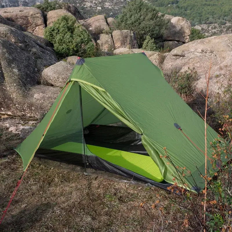 a tent pitched on a rocky mountain
