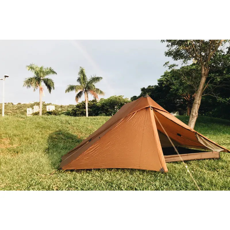 a tent pitched in the grass