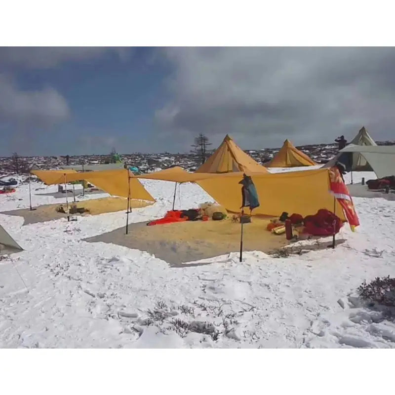 a group of tents are set up in the snow