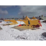 a group of tents are set up in the snow