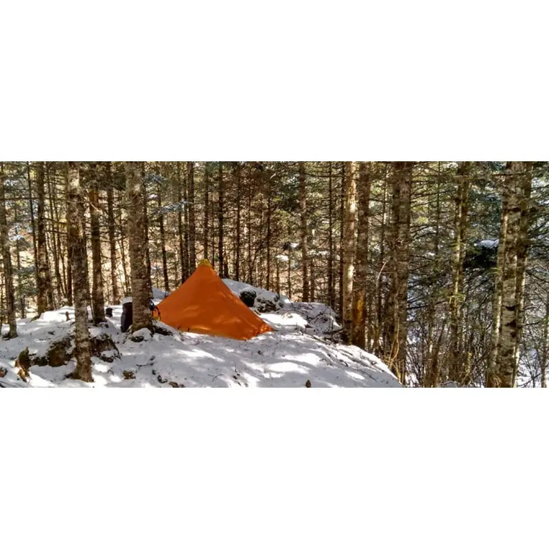 a tent in the snow in the woods