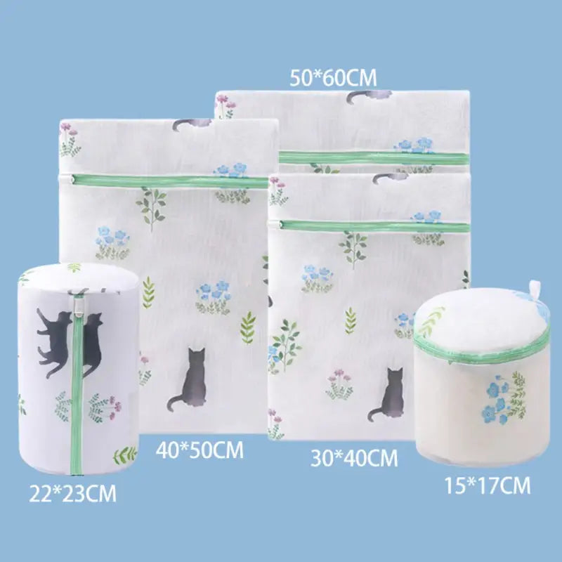 three bags with cat designs and a cat on them