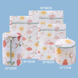 a set of three storage bags with a pattern of clouds and suns
