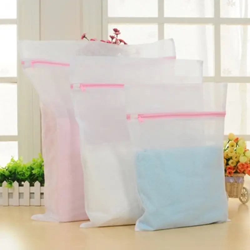 three bags of white and pink color on a table