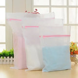 three bags of white and pink color on a table