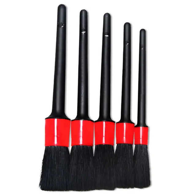three black and red brushes with a red handle