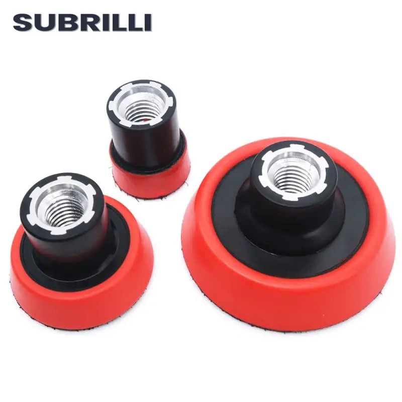 three red and black rubber wheels with nut holes on them