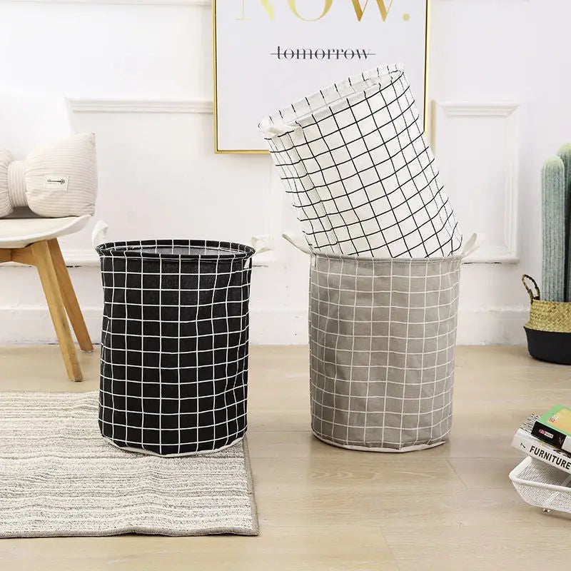 three black and white laundry baskets on the floor