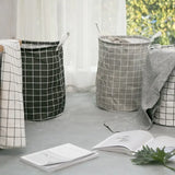 three black and white baskets on a table