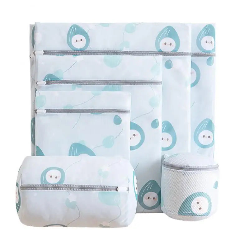 a blue and white baby bed set with a blue and white bird print