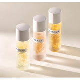 three bottles of perfumes with a white background