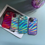 three iphone cases with irl - colored hologized designs on them
