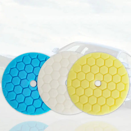three different colored polish pads on a white surface