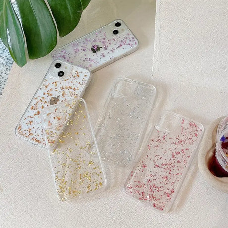 three clear cases with glitter and gold glitter