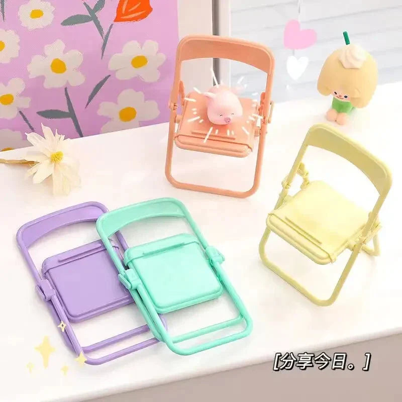 three different colored plastic chairs on a table