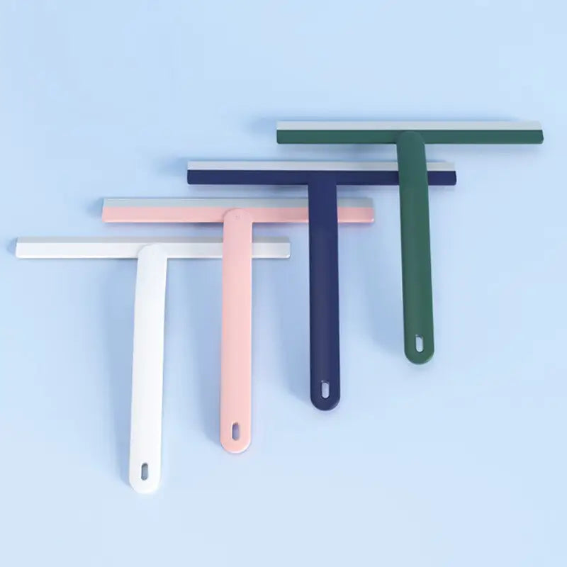three different colored plastic pegs on a blue background