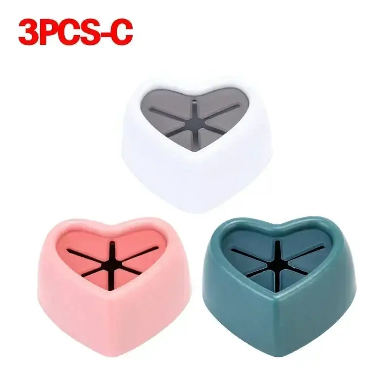 three different colored heart shaped plastic cutters with a black handle