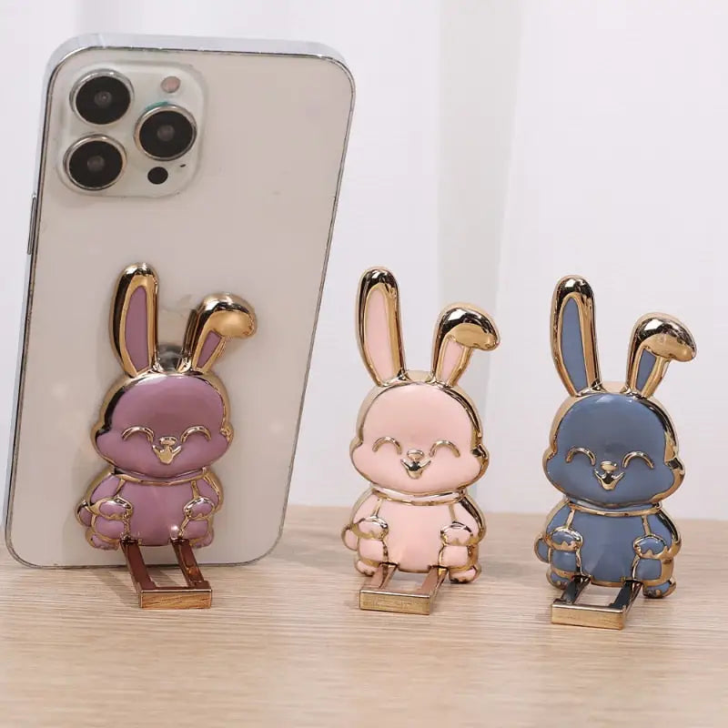 three cute rabbit phone cases with a gold plated stand