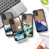 three iphone cases with mountains and trees on them