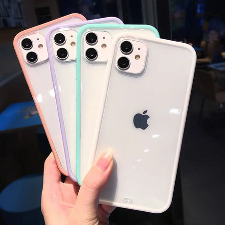 a woman holding up three iphones in her hand